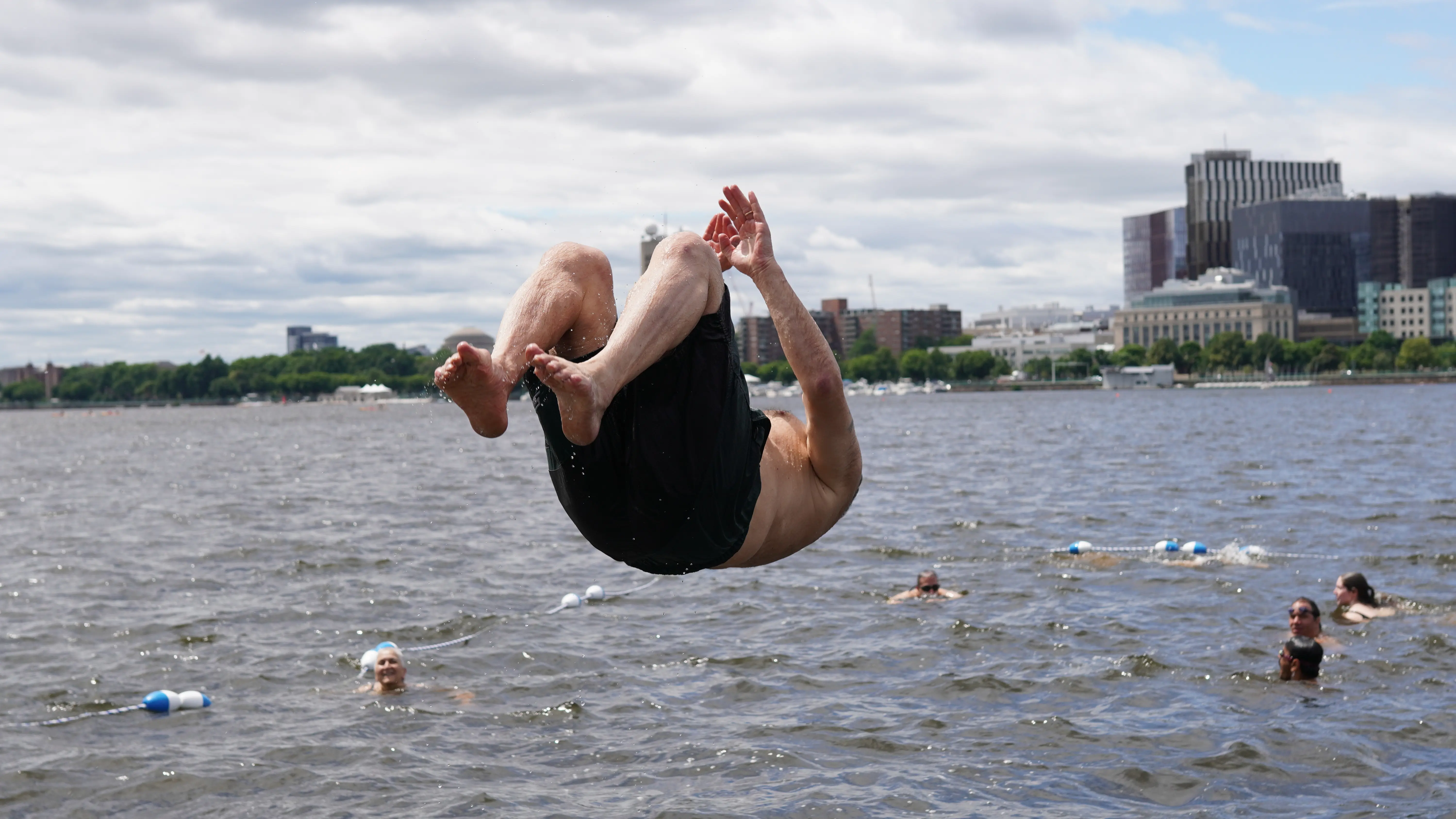 Man jumping into Charles River
